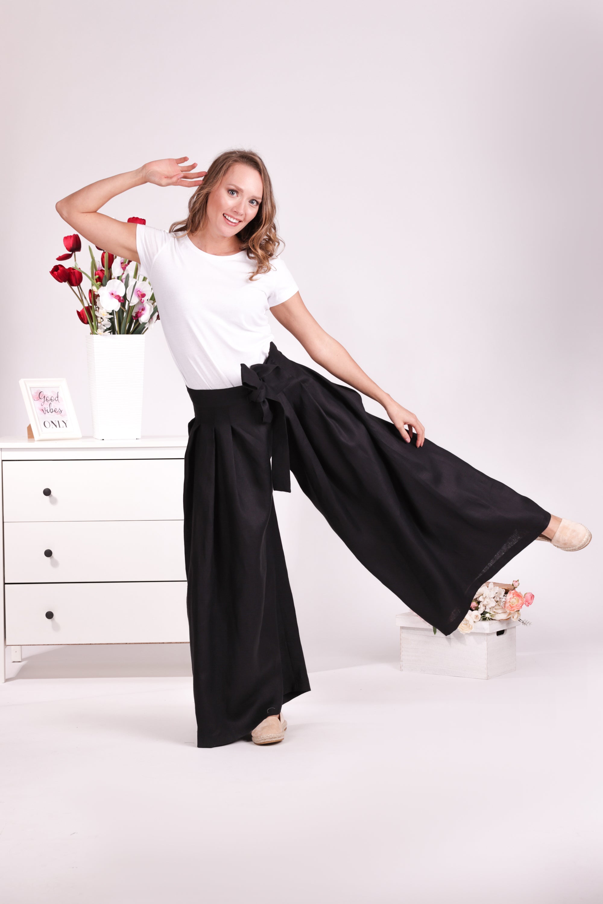 Relaxed black linen trousers with bow detail