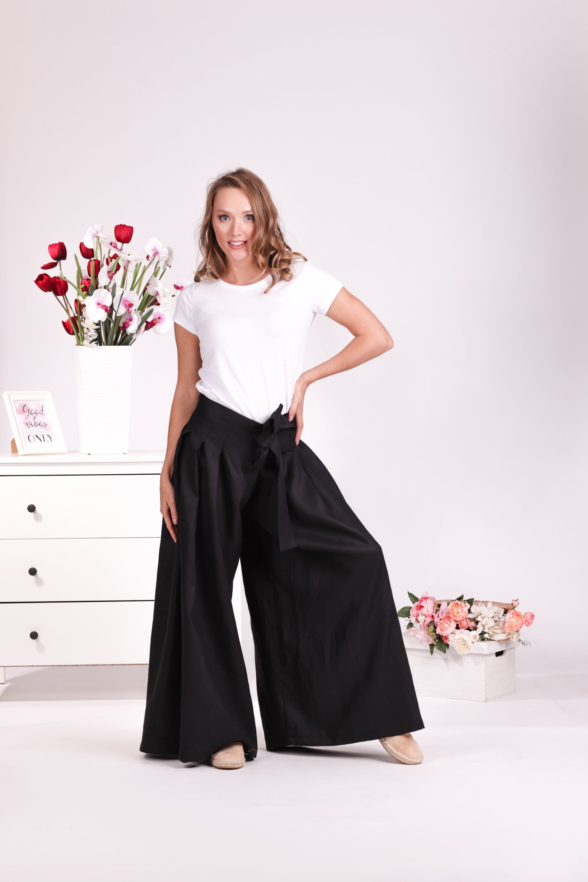 Relaxed black linen trousers with bow detail