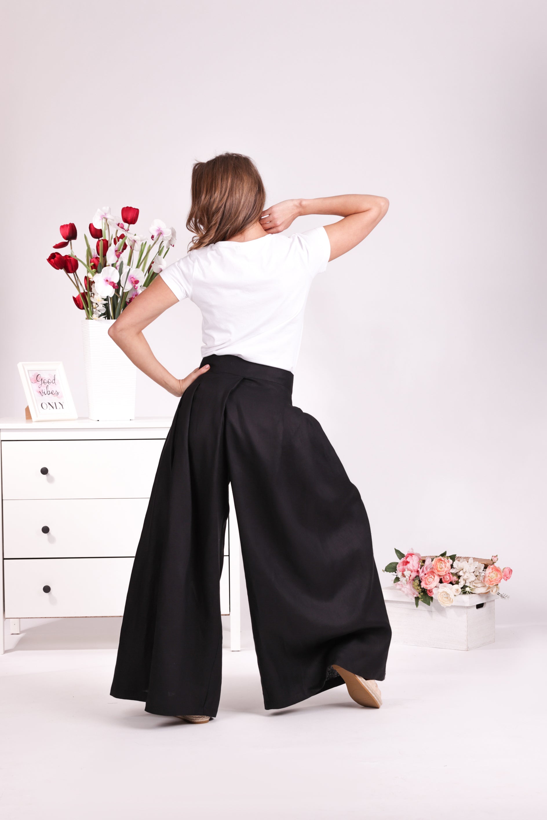 Relaxed black linen trousers with bow detail