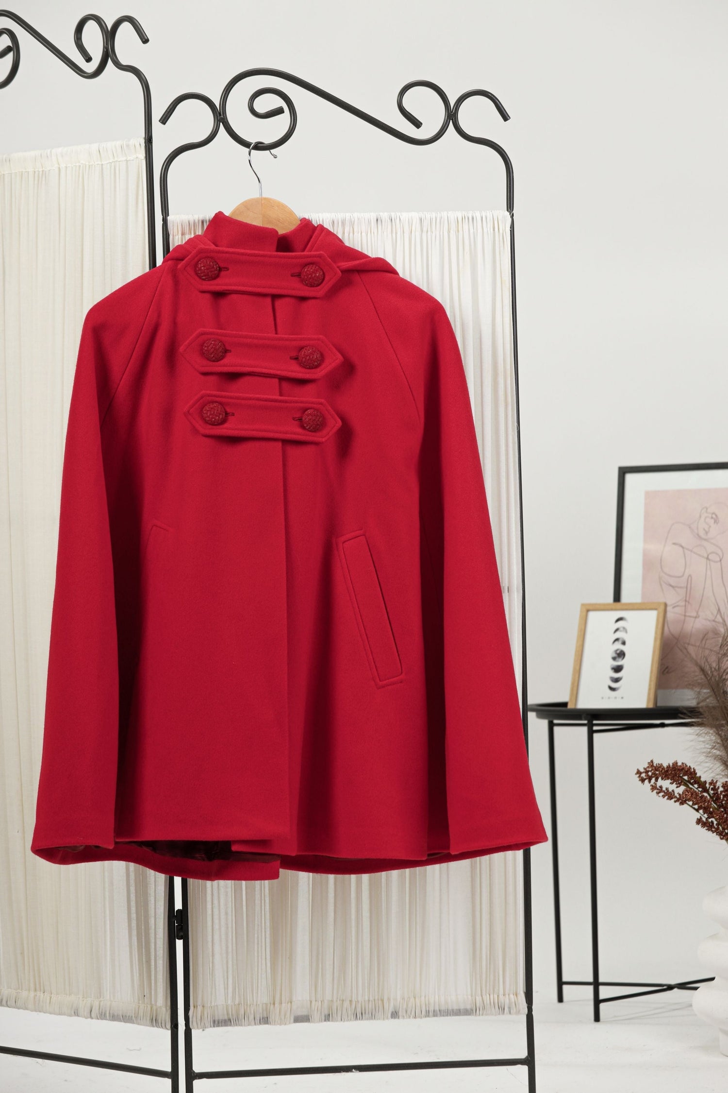 Image of a hanging elegant Hooded Wool Cape Coat from NikkaPlace | Effortless fashion for easy living