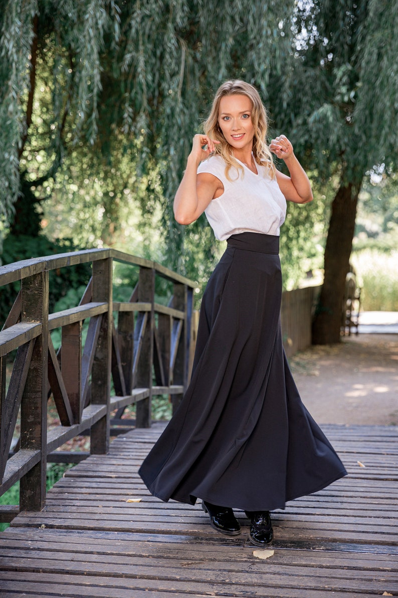 Model wearing High Waisted Maxi Skirt in front of a city background - from NikkaPlace | Effortless fashion for easy living